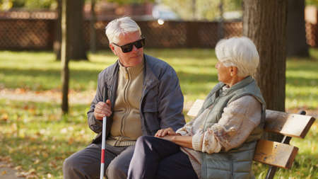 Handicapped blind people emotional support rehabilitation concept medium shot selective focus park background . High quality photoの写真素材