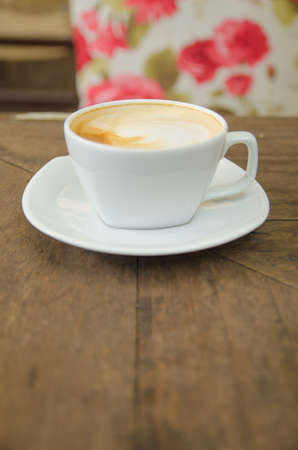 A cup of coffee on wooden tableの写真素材