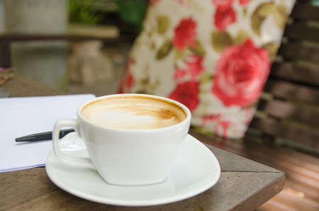 A cup of coffee,paper and a penの写真素材
