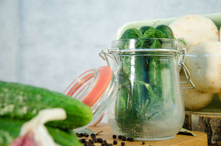 Mushrooms garlic cucumber tomato pepper in a jar.の写真素材