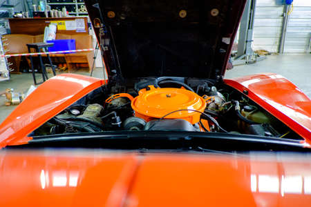 Windshield view of the engine of a vintage sport car. Sport car underhood space.