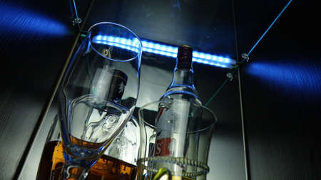 blue shots glasses and two bottles with whiskey.の写真素材