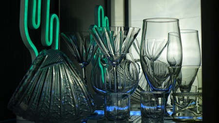 Glasses and shots highlighted by green light on a black background. Low key.の写真素材