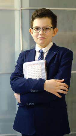European boy in school uniform with notebook.の写真素材
