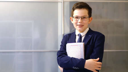 European boy in school uniform with notebook.の写真素材