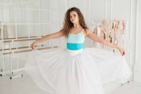 Young beautiful girl ballerina with curly hairの写真素材
