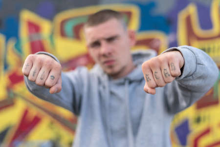 ACAB tattoo on the arm of a bully man