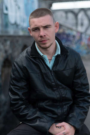 Bully criminal in black leather jacket by dayの写真素材