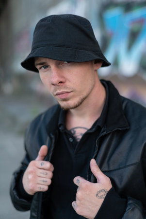 Bully criminal in black leather jacket by day