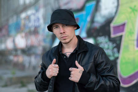 Bully criminal in black leather jacket by day