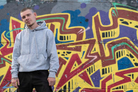 A bully guy in a light sports jacket with a hoodの写真素材