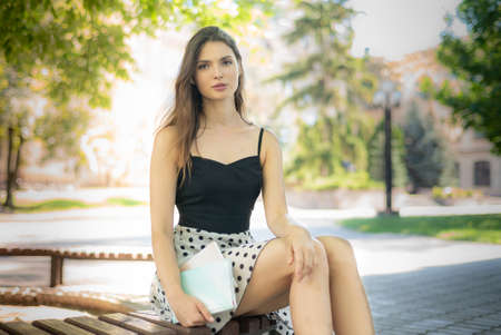 Girl student on a bench in the daytime