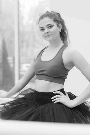 Black and white photo of flexible slender young girl ballerina. BW
