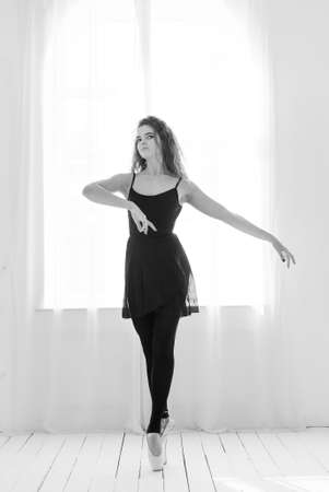 Girl ballerina with curly hair. Black and white photo. BWの写真素材