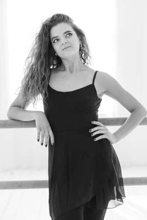 Girl ballerina with curly hair. Black and white photo. BWの写真素材
