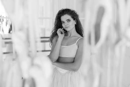 Girl ballerina with curly hair. Black and white photo. BW