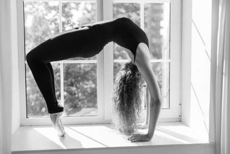 Girl ballerina with curly hair. Black and white photo. BW