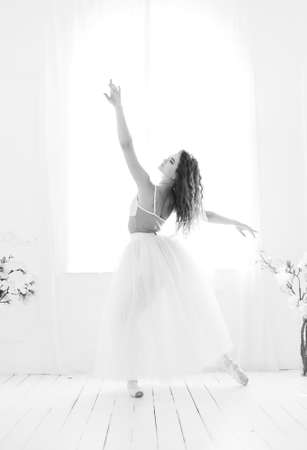 Girl ballerina with curly hair. Black and white photo. BWの写真素材