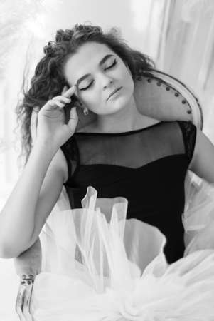 Girl ballerina with curly hair. Black and white photo. BWの写真素材