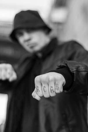 ACAB tattoo on the arm of a bully man. Black and white photoの写真素材