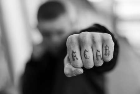 ACAB tattoo on the arm of a bully man. Black and white photoの写真素材