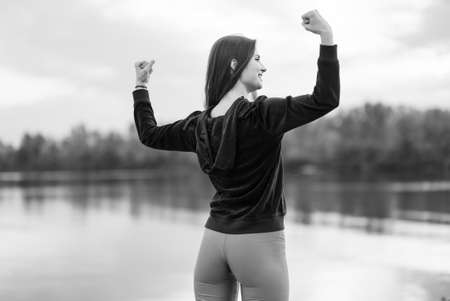 Portrait of a beautiful young sporty brunette girl. Black and white photo. BWの写真素材