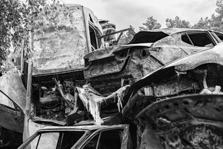 Shot and burned cars during the war in Ukraine, black and white photoの写真素材