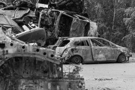 Dump of war-destroyed cars in Ukraine, black and white photoの写真素材