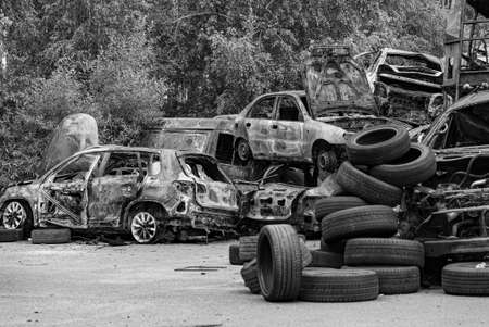 Dump of war-destroyed cars in Ukraine, black and white photoの写真素材
