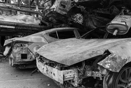 Dump of war-destroyed cars in Ukraine, black and white photoの写真素材