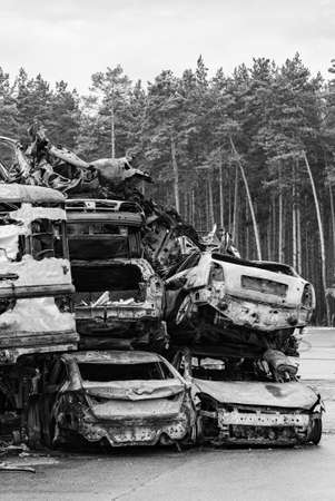 Dump of war-destroyed cars in Ukraine, black and white photoの写真素材