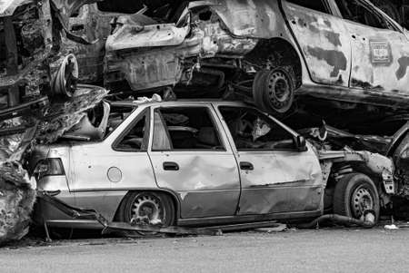 Shot and burned cars during the war in Ukraine, black and white photo