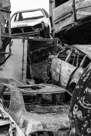 Dump of war-destroyed cars in Ukraine, black and white photoの写真素材