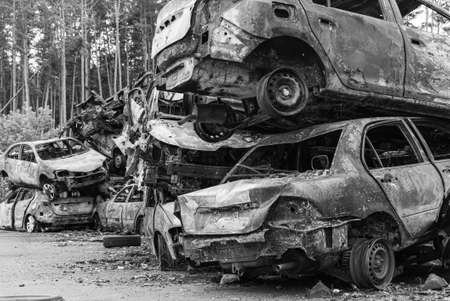 Dump of war-destroyed cars in Ukraine, black and white photoの写真素材