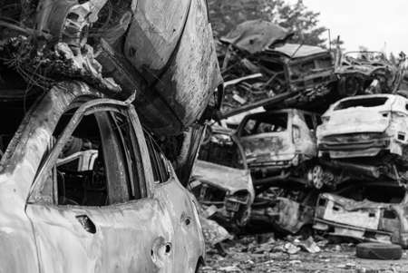 Black and white photo of the war in Ukraine - destroyed cars in Bucha districtの写真素材