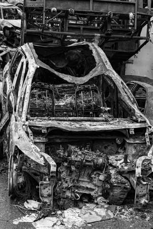 Black and white photo of the war in Ukraine - destroyed cars in Bucha districtの写真素材