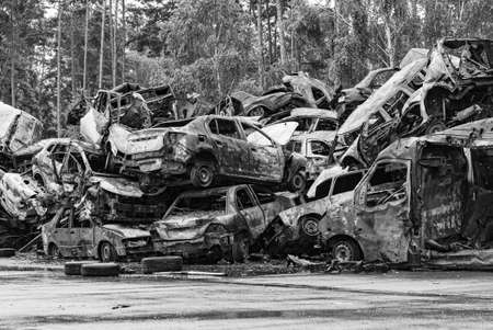 Black and white photo of the war in Ukraine - destroyed cars in Bucha district