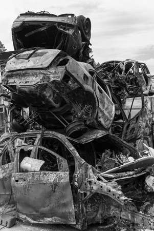 Dump of war-destroyed cars in Ukraine, black and white photoの写真素材