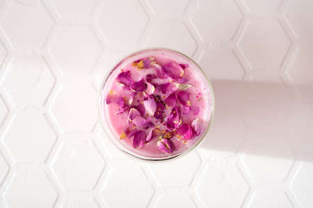 Pink rose milk with rose petals. Healthy drink moon milk.の写真素材