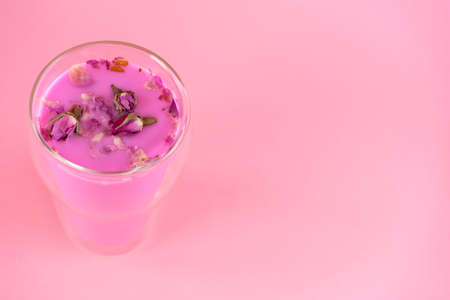 Pink rose milk with rose petals. Healthy drink moon milk. Copy space.の写真素材
