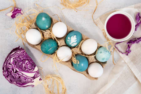 Step by step painting Easter eggs. Step 6 - natural coloring of eggs in blue color with red cabbage leaves.の写真素材