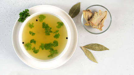 Homemade turkey bone broth in white bowl. Healthy. Collagen is good for joints.の写真素材