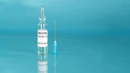 Coronavirus sars-cov-2 vaccine. Covid-19 vaccination with vaccine ampoule and syringe injection tool...