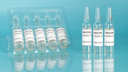 Coronavirus immunization treatment with vaccine ampoules. End of the pandemic concept.