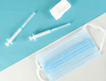 Syringe for vaccination with protective face masks against viruses. Coronavirus Covid-19 vaccine....