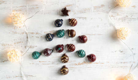 Chocolate candies in the shape of Christmas tree and Christmas balls. Top view.の写真素材