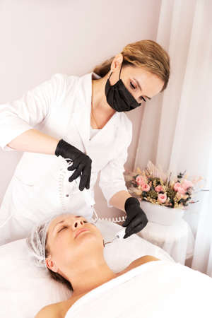 Micro current therapy at the cosmetologist or beautician. Cosmetology beauty skincare anti-age...
