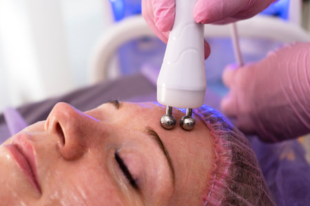 Micro current therapy. Cosmetology beauty skincare procedure by beautician.