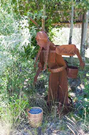 Metal sculpture depicting the collecting of saskatoon berriesのeditorial素材