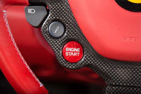 Close up of start engine button on red leather car steering wheelの写真素材